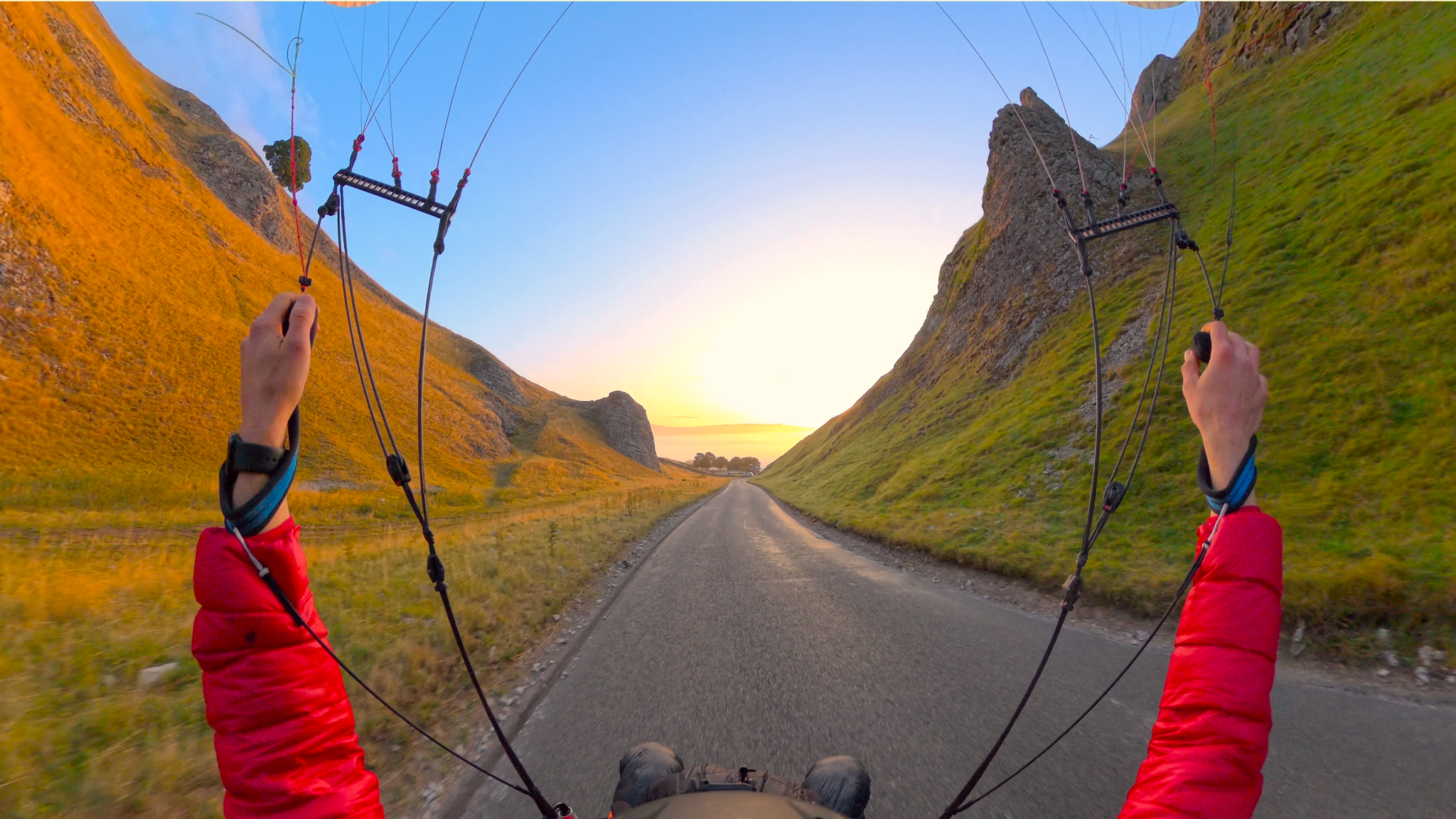 First-person flight through a sunlit rocky valley